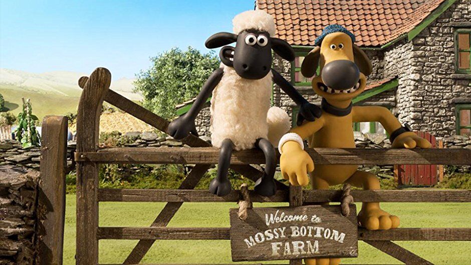 Shaun the Sheep sitting on a fence