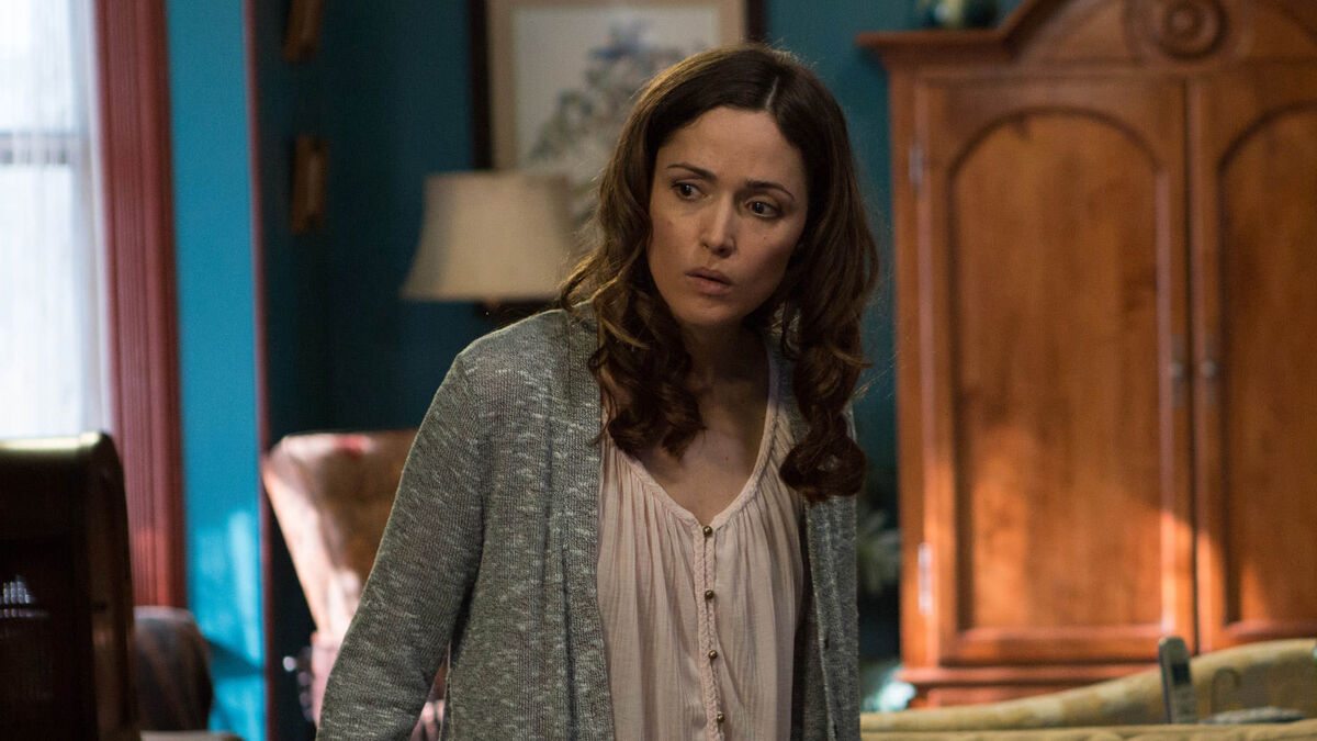 rose byrne as Renai Lambert checking out something strange in her house in Insidious