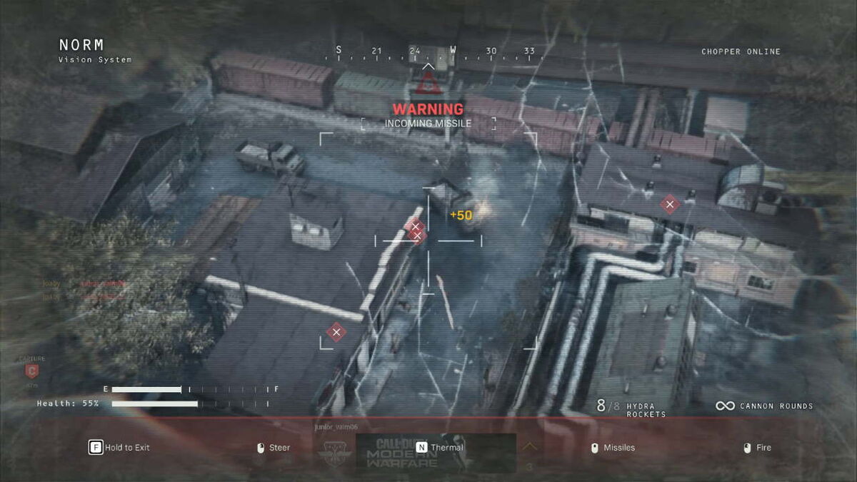 A view from a helicopter as a chaingun is fired at several enemies below.