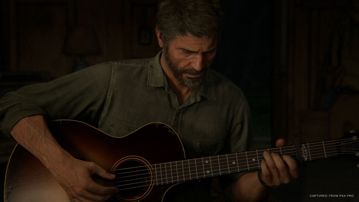 Joel playing guitar in The Last of Us Part II