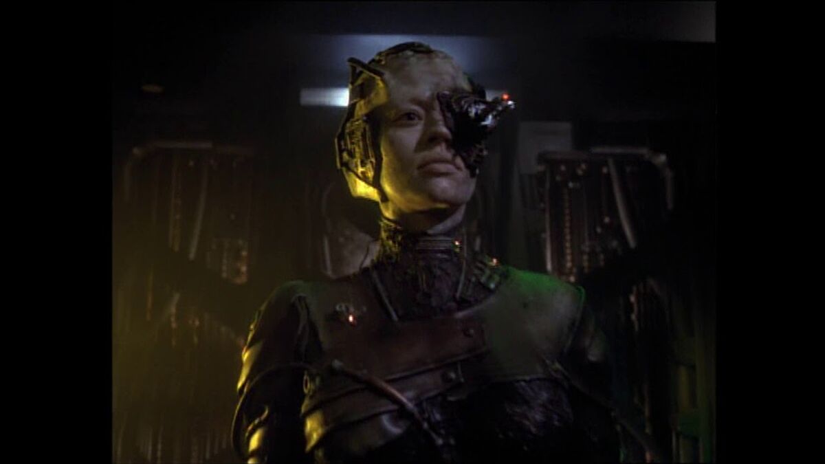 The female Borg, 7 of 9 serves as the representative for the collective. She stands in front of a mechanical womb.