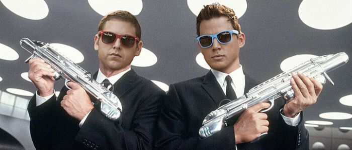 Jonah Hill and Channing Tatum in Men in Black suits and guns
