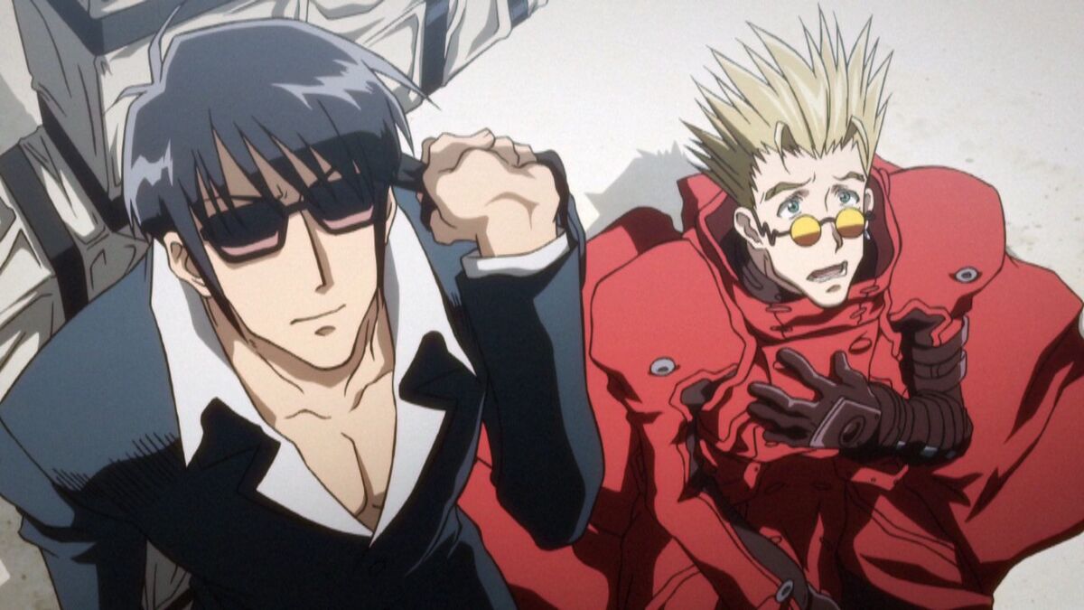Nicholas D Wolfwood has black, short hair with shaggy bangs, dark glasses and his cross-shaped weapon, the Punisher over his shoulder and Vash has spikey blonde hair, round orange glasses and his trademark red duster 