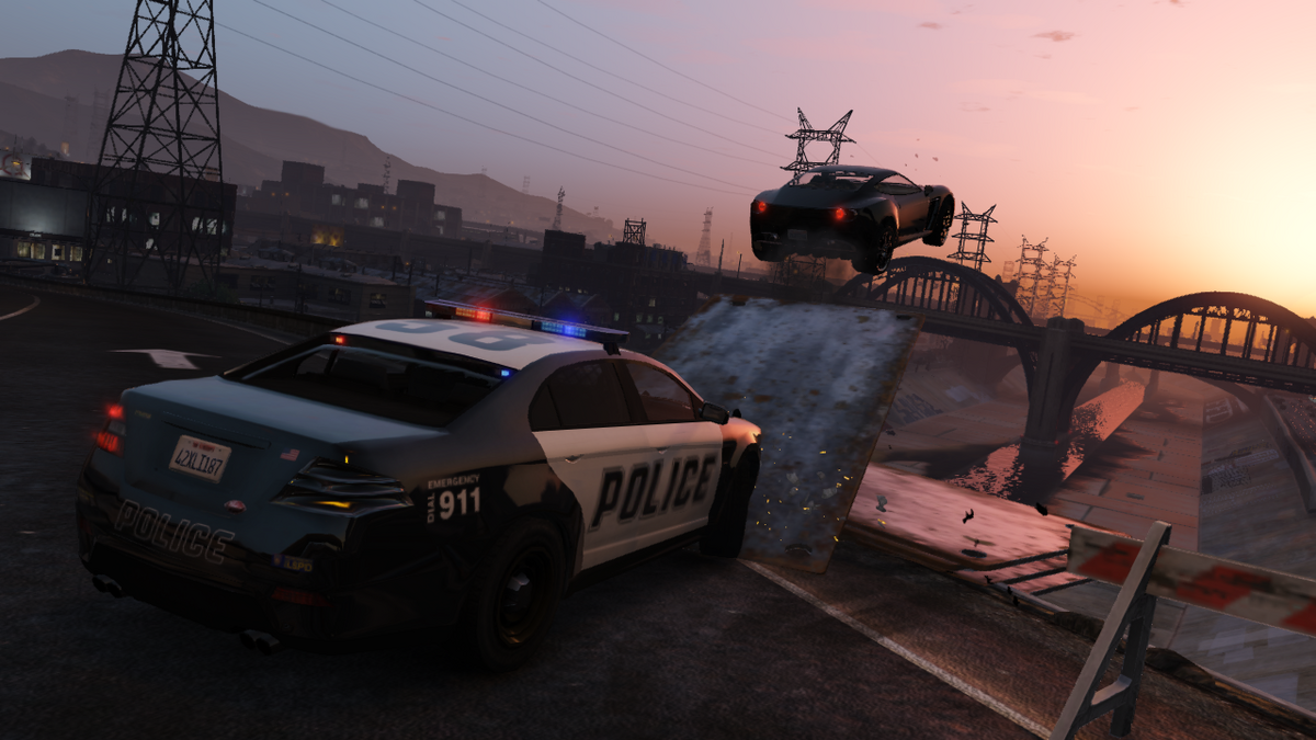 A car jumping over the river away from a police car in Grand Theft Auto V.