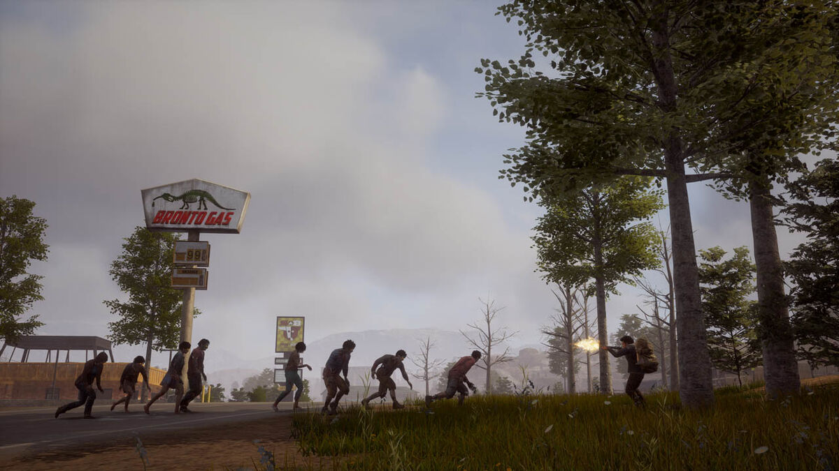 A survivor shoots into a pack of zombies on a forest's edge.