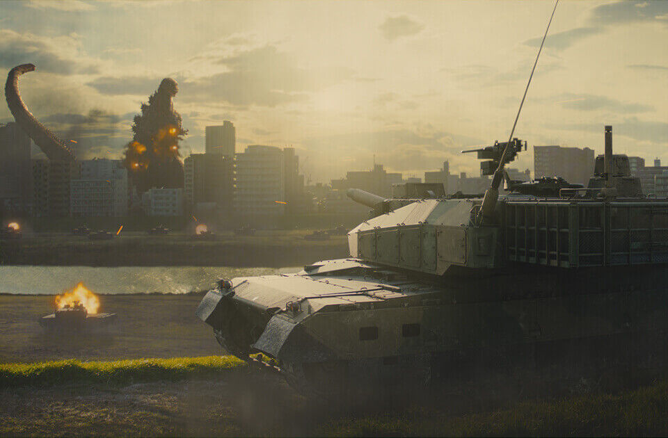 Godzilla destroys a city while a tank stands by