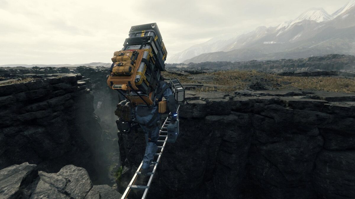Sam Porter Bridges walks across a crevasse on a ladder with a massive pack.