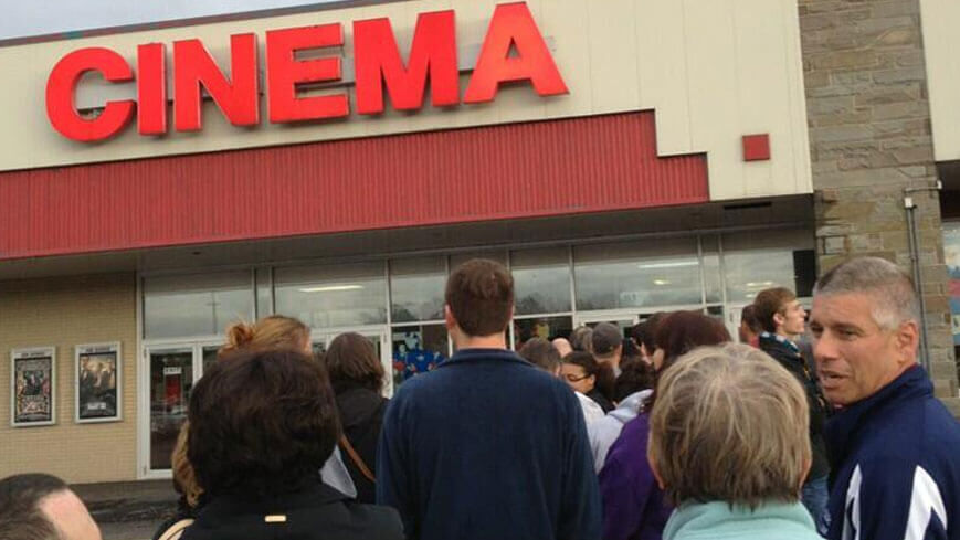 a long line of moviegoers wait to enter the cinema
