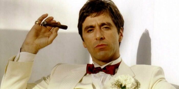 scarface al pacino holding a cigar