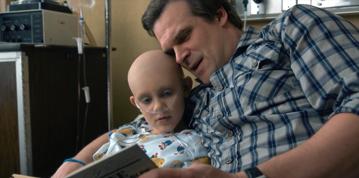 jim hopper reading Sarah-Hopper a book in a hospital bed on stranger things