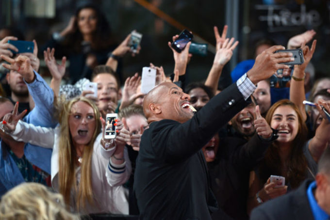 the rock taking selfies with fans