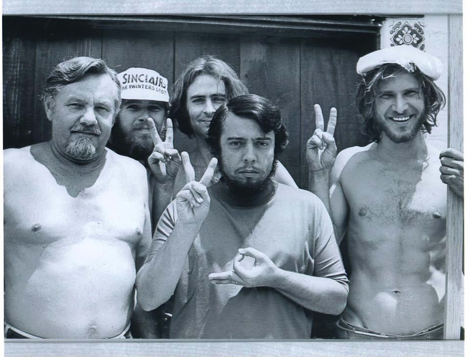 harrison ford with fellow carpenters posing with peace signs