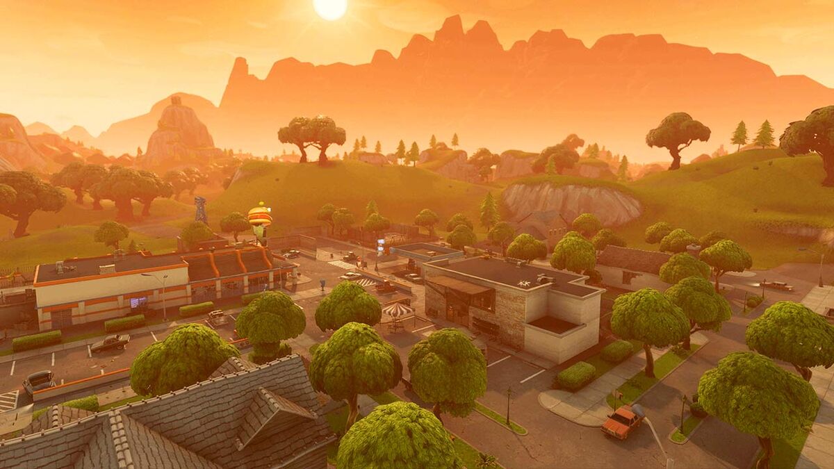 A panoramic shot of an abandoned town in Fortnite. Not pictured but there: about a dozen 14-year olds who will absolutely kill you with a pick axe.