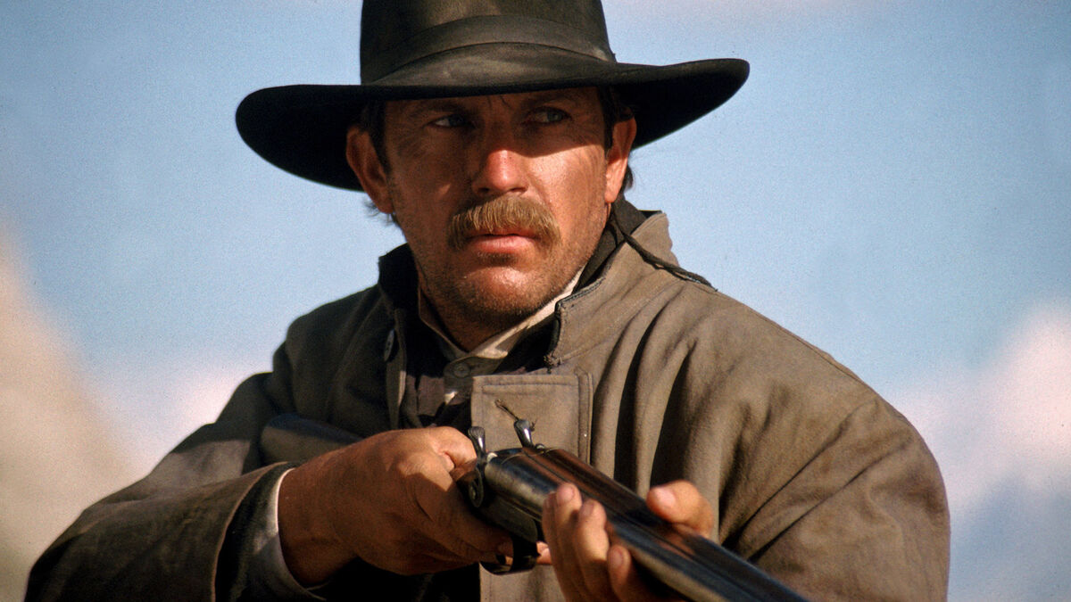 magnificent-seven-western-actors-kevin-costner with cowboy hat mustache and rifle at the ready