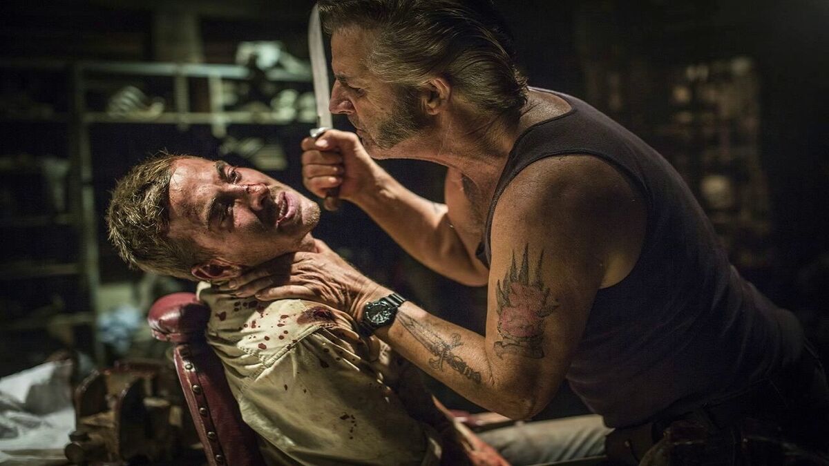 Mick Taylor terrorises a hostage in Wolf Creek.