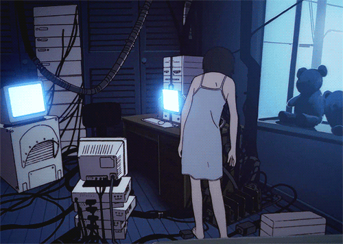 Lain sitting in front of computer