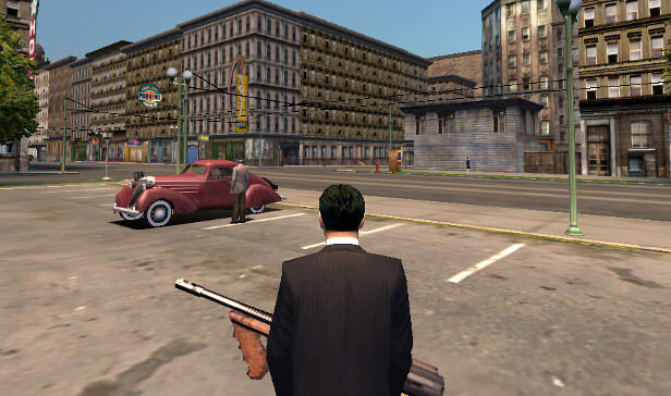 mafia video game Tommy approaches an old car holding a gun