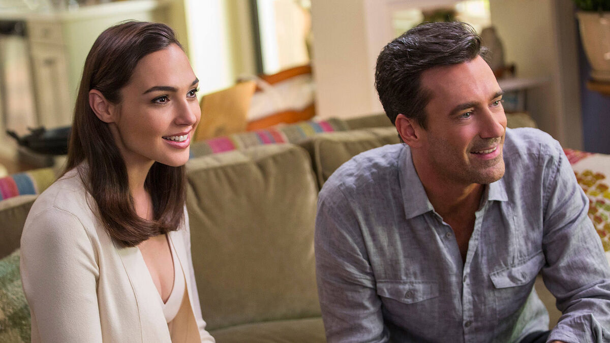 Gal Gadot and Jon Hamm the perfect suburban couple in their perfect suburban living room