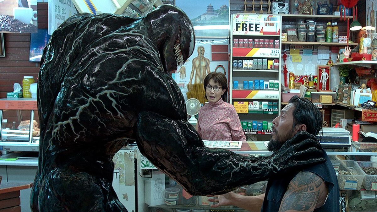 Venom grabbing a guy by the neck