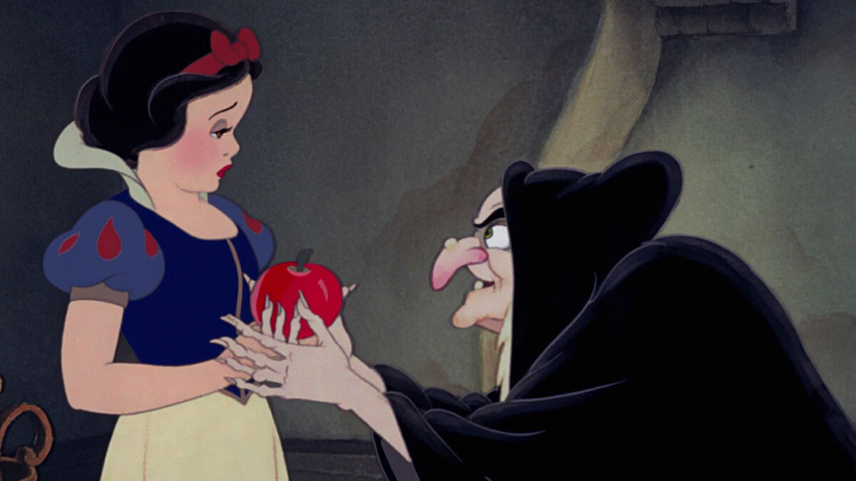 The Evil Queen, disguised as an old woman, gives Snow White the poisoned apple.