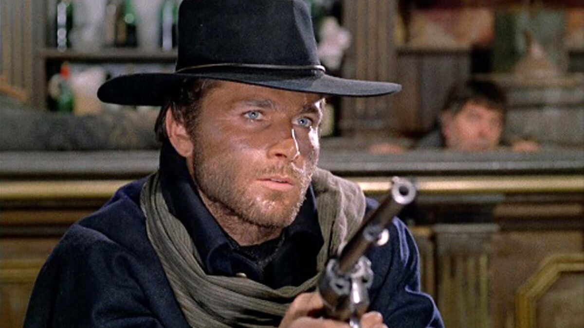 magnificent-seven-western-actors-franco-nero holding six-shooter in Western bar