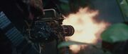 Nikolai fires his Minigun at Royce
