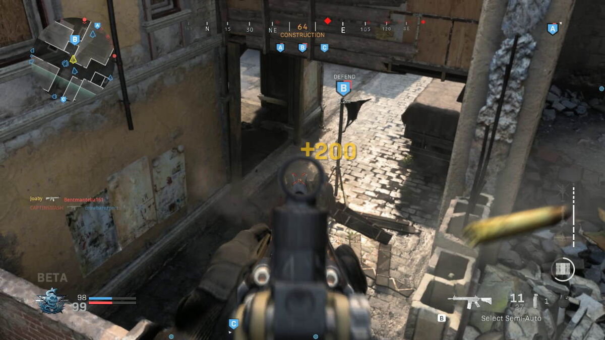 Aiming down rifle sights at an enemy on the ground, from the second level window.