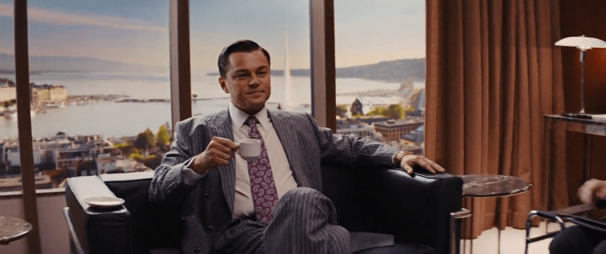 wolf of wall street leonardo dicaprio in office drinking coffee