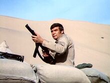 The Moon and the Desert - Steve firing a gun