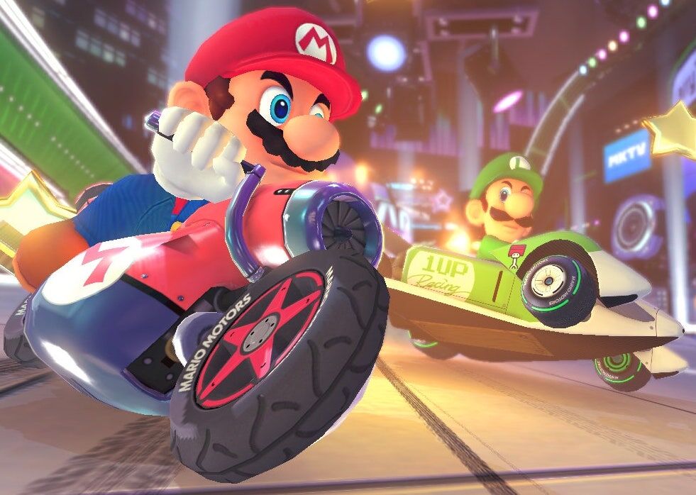 Mario rides a motorcycle in Mario Kart while Luigi and Yoshi trail him in the background