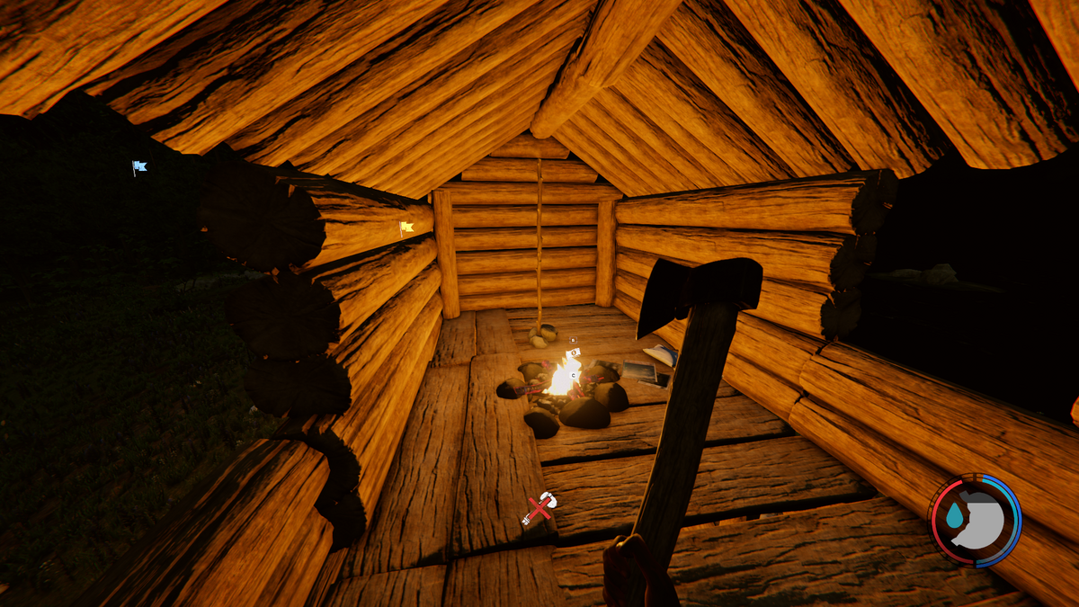 A log cabin is lit by a fire inside.