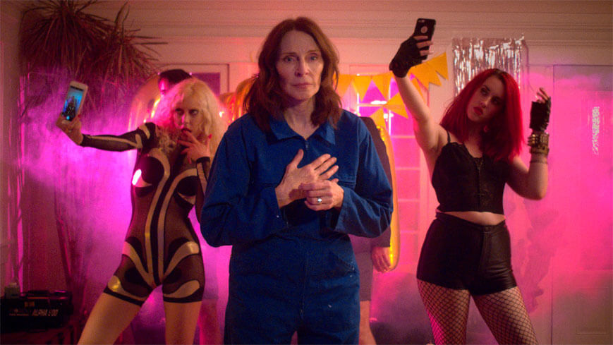 Gates McFadden appears with selfie-taking extras in an Onsen video