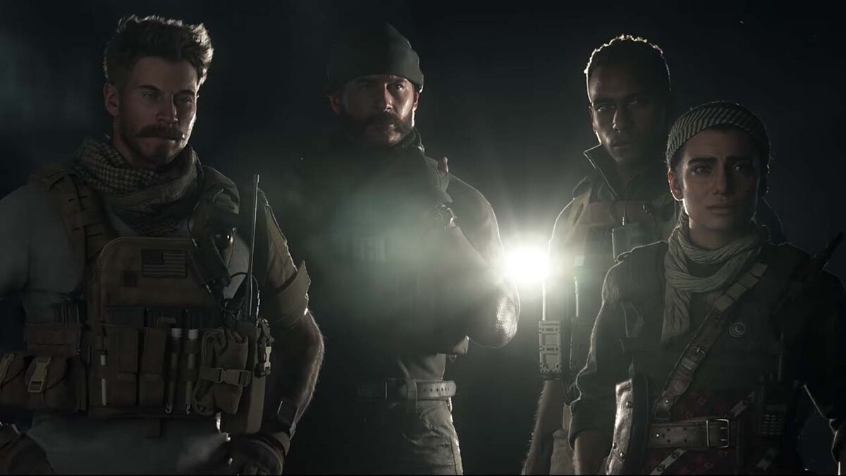 Four people look into the camera with a flashlight, including Captain Price.