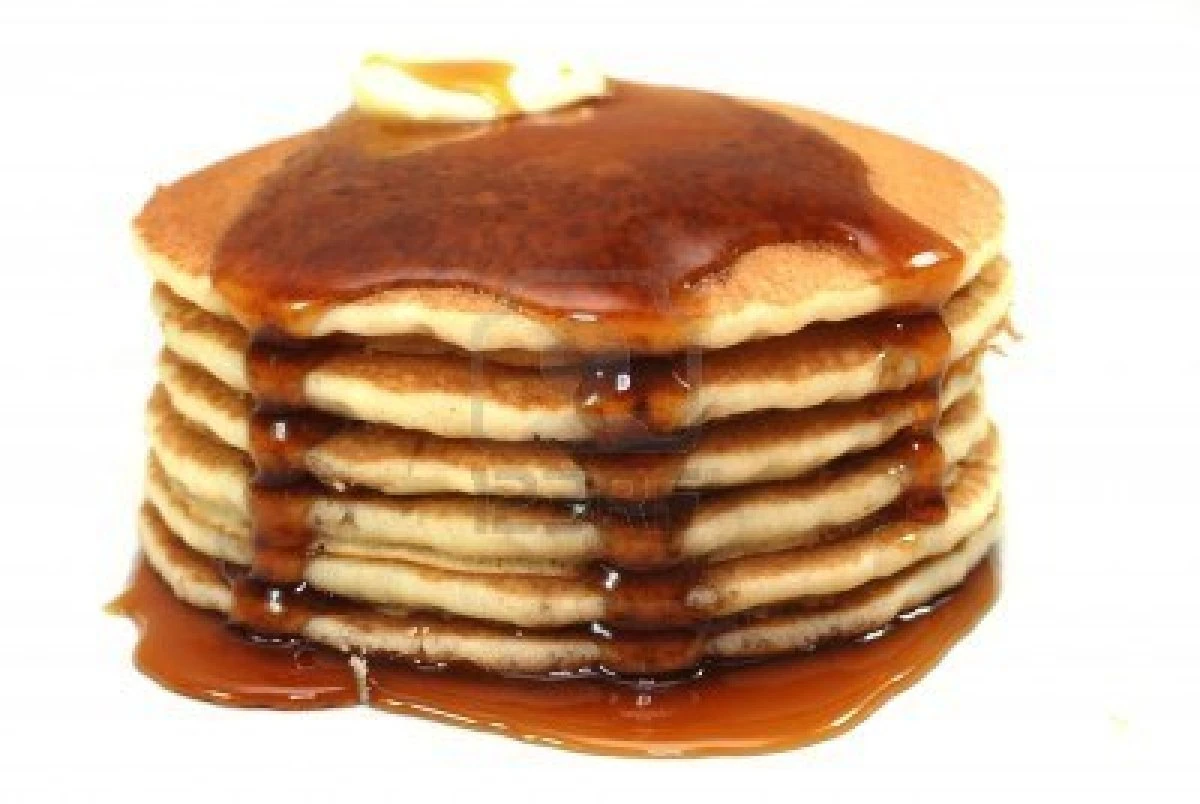 Image 1898048stackofpancakesandsyrupisolatedonwhite