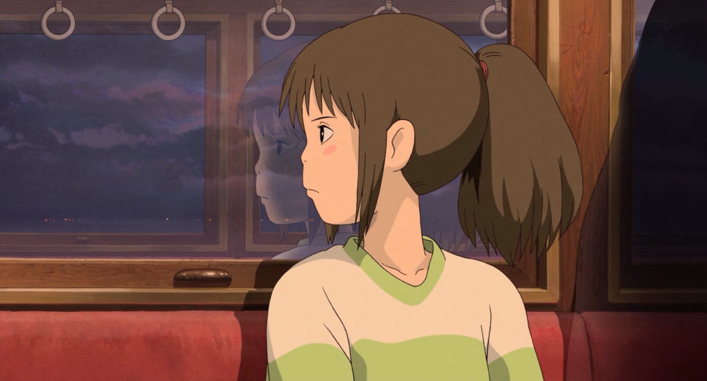 Chihiro looking towards her destination on the train.