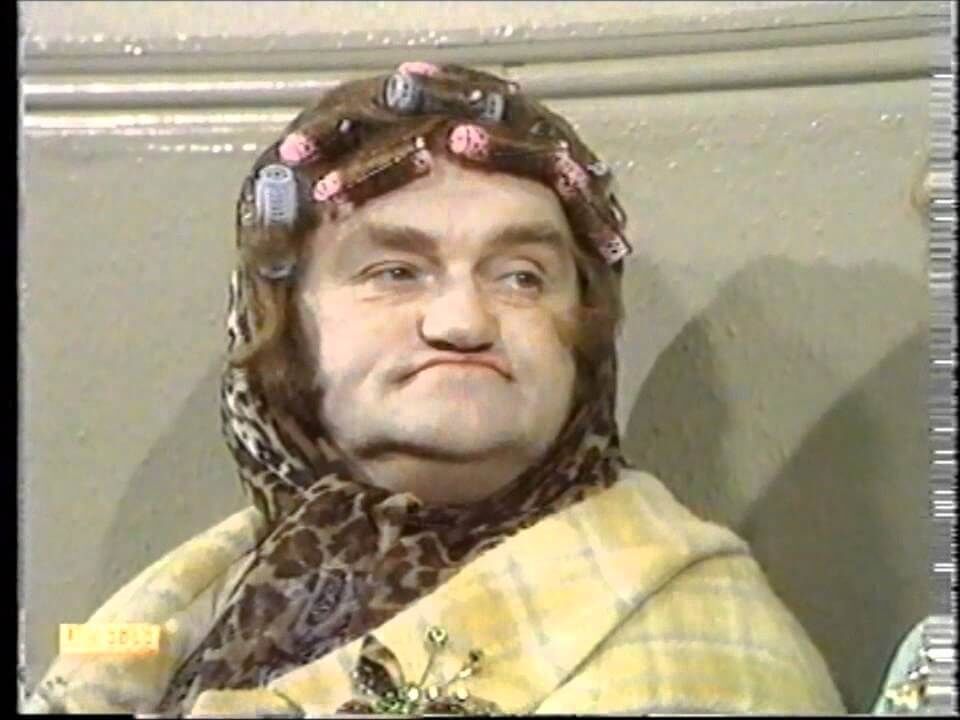 Les Dawson dressed as an old woman wearing curlers
