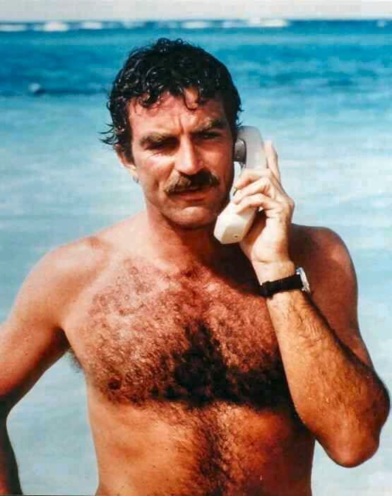 magnum-pi-tom-selleck shirtless at the beach on a cordless phone