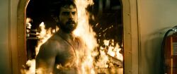 Clark walking through fire