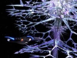 The Enterprise is dwarfed by the enormous space alien known as the Crystalline Entity