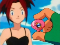 EP087 Ash mirando la medalla Ojo de Coral