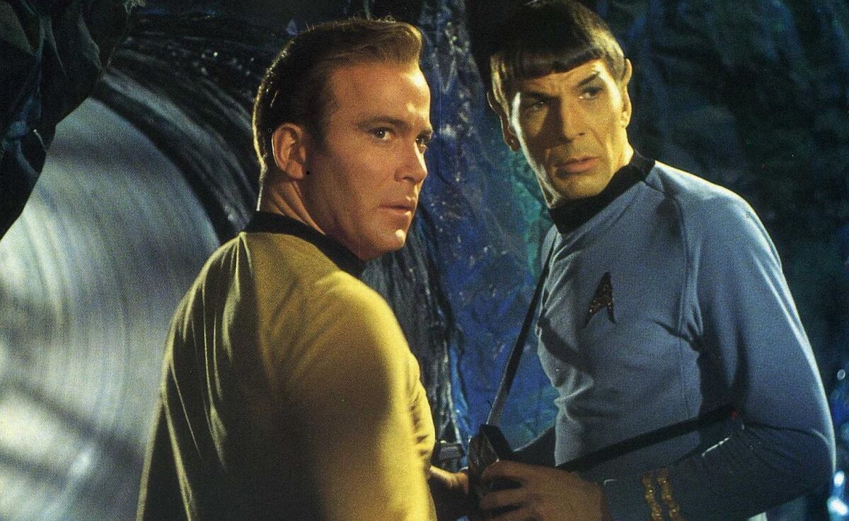 Kirk and Spock in front of a Horta tunnel look anxiously behind them