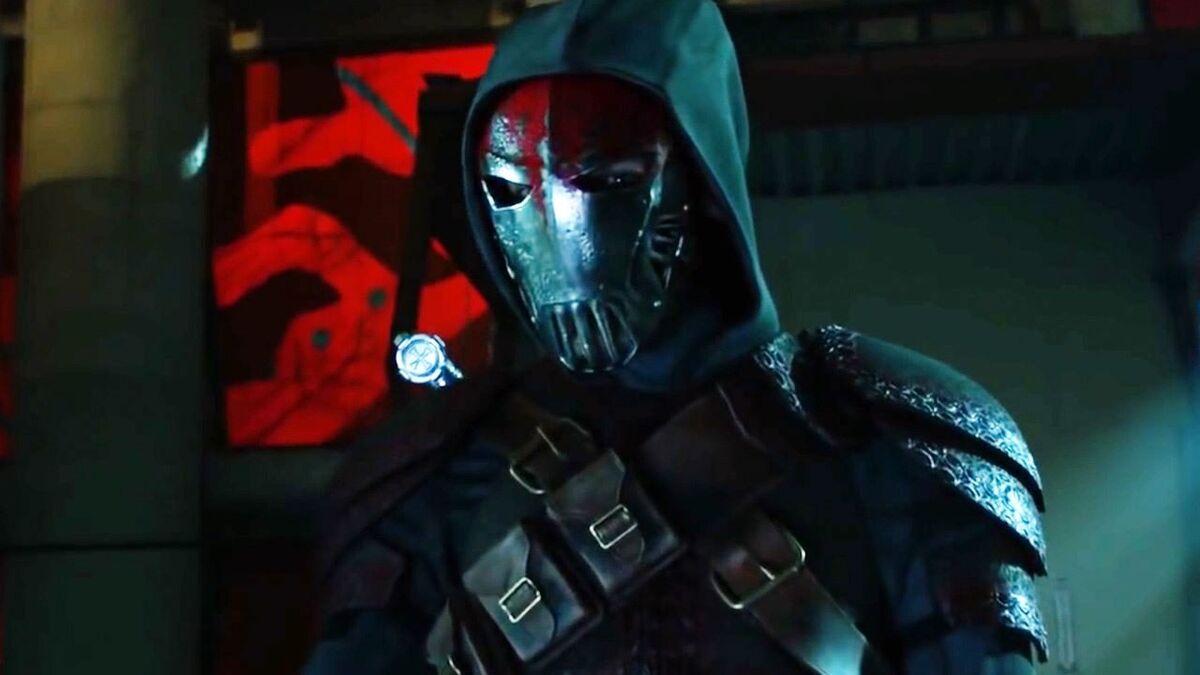 Azrael is seen in an iron mask, and dark cape and hood. He is wearing an ammunition belt that stretches across his chest like an X.