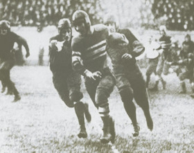 McMillin with the football, pursued by other players