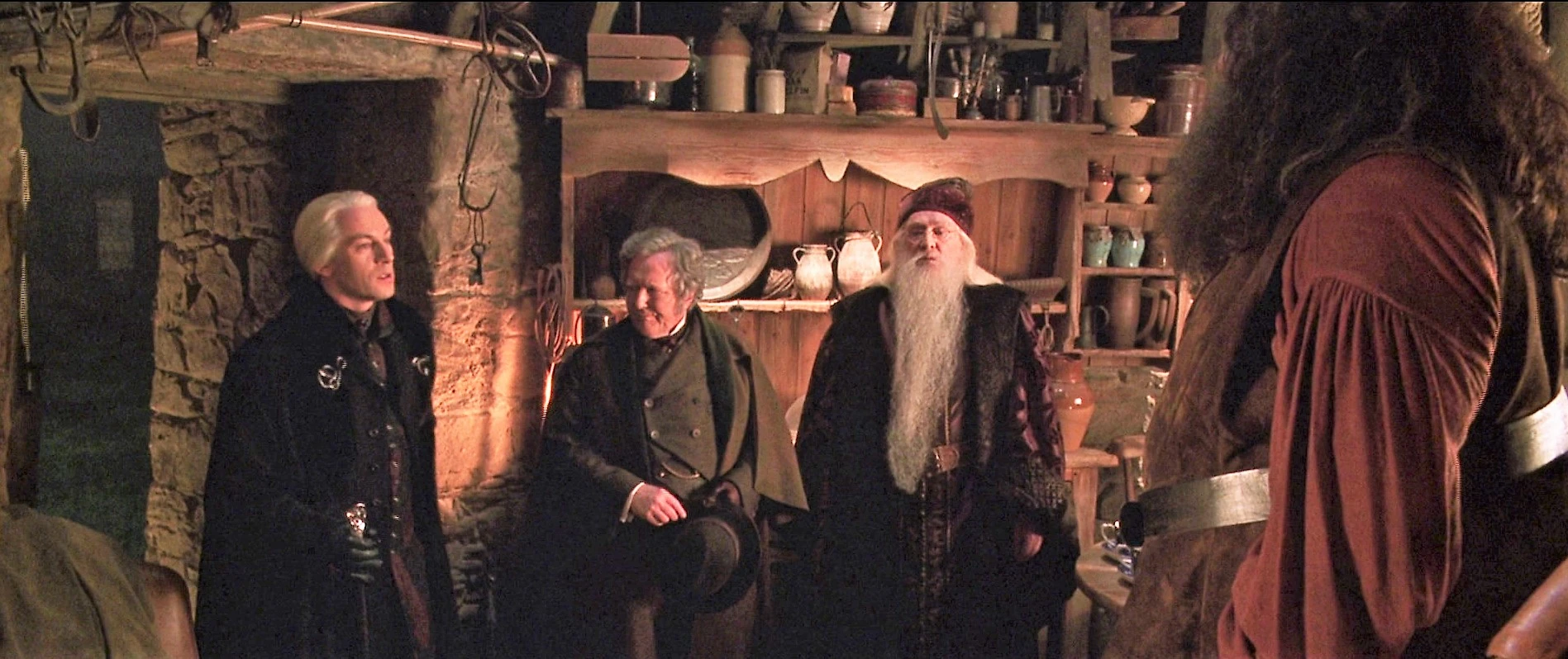 Image Hagrid's hut with visitors Malfoy Fudge Dumbledore.jpg Harry
