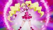 Cure Peach poses with sparkles