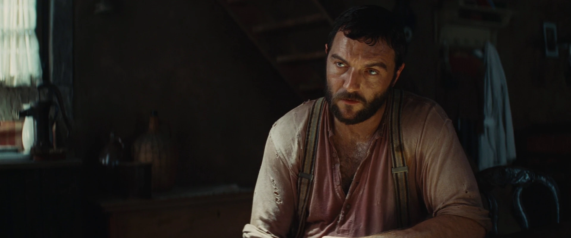 Image Perrier LaPadite looks at Hans Landa at the table.jpg