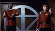 Terrell and Chekov aim phasers