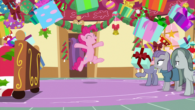 File:Pinkie Pie bursts out of pile of presents MLPBGE.png