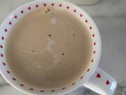 Cream in coffee in the shape of Snoopy