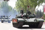 122236389-donetsk-donetsk-people-republic-ukraine-–-may-9-2019-armored-soviet-tanks-t-72-driving-through-the-m